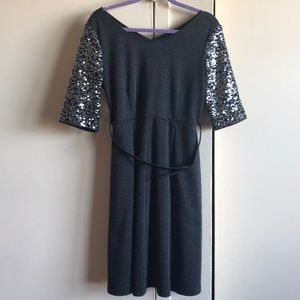 A grey dress with sequins and a belt
